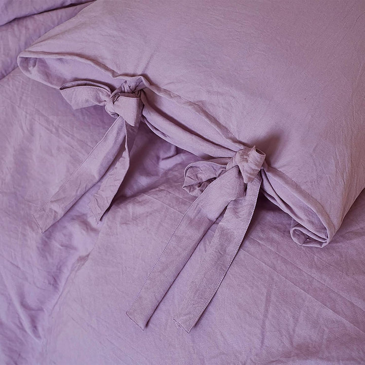 Close-up of the intricate knot detail on the lilac duvet cover from the VibeCore Aesthetic Knot So Ordinary Duvet Cover Set, highlighting the unique texture and stylish design for a cozy, chic bedroom or dorm look.
