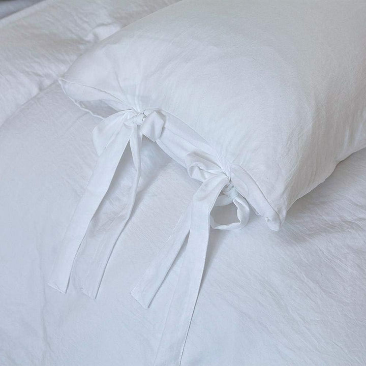 Close-up of the intricate knot detail on the white duvet cover from the VibeCore Aesthetic Knot So Ordinary Duvet Cover Set, highlighting the unique texture and stylish design for a cozy, chic bedroom or dorm look.