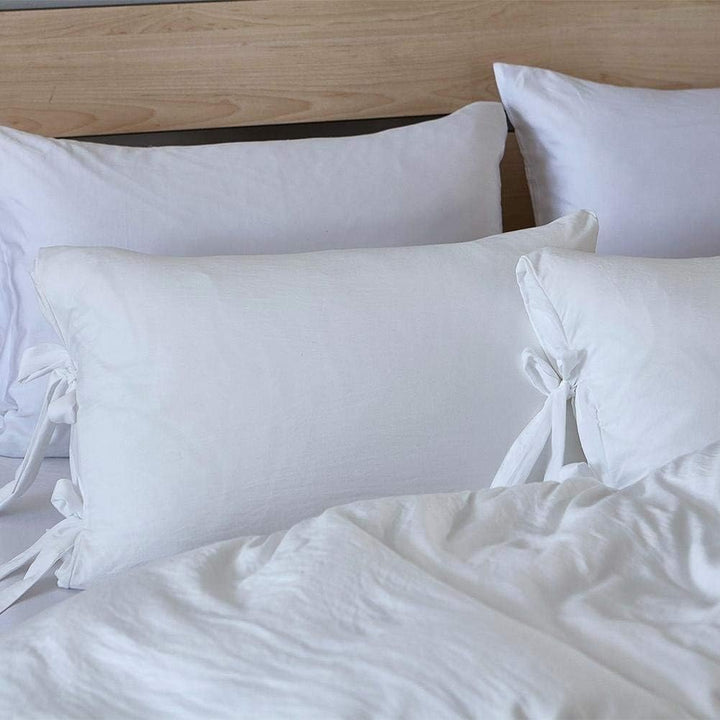 Close-up of the white pillowcase from the VibeCore Aesthetic Knot So Ordinary Duvet Cover Set, featuring a soft, textured fabric with unique knot edge detailing for an added cozy, stylish vibe to your bedroom or dorm. 