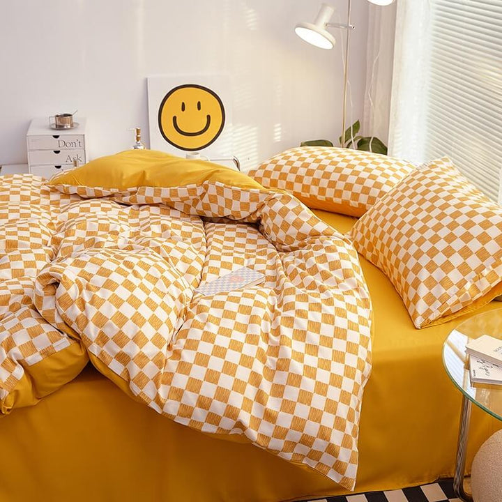 Side right view of the 'VibeCore Mini Checkered Bedding Set' in Mustard Yellow, showcasing the sleek, modern checkered pattern. The soft fabric and trendy design create a stylish and comfortable vibe, making it a perfect addition to any bedroom or dorm.