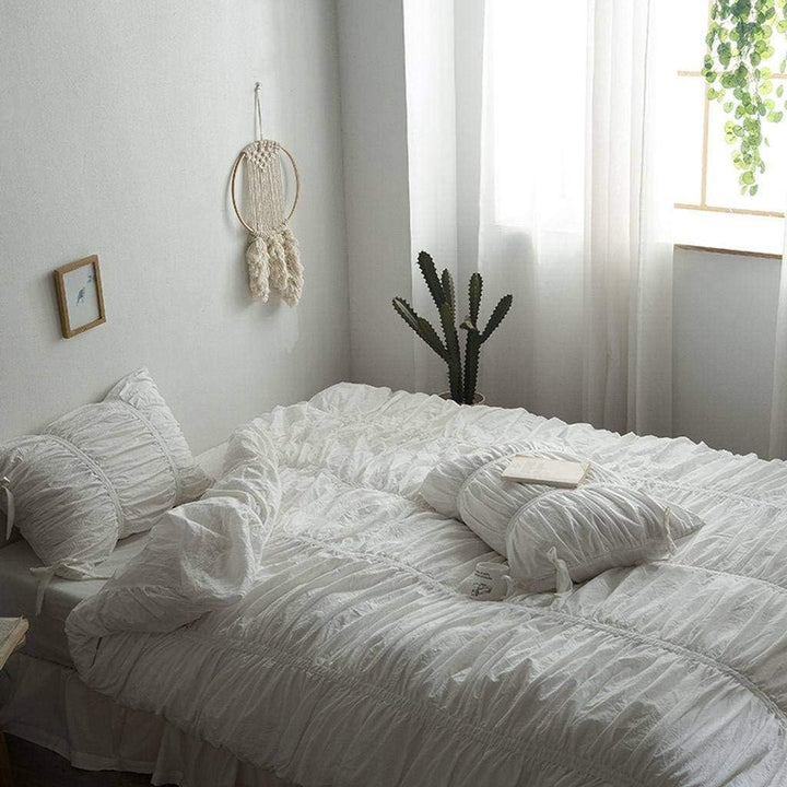 Side view highlighting the pleated details of the VibeCore White Timeless Elegance Pleated Bedding Set, emphasizing its sophisticated texture and elegant design.