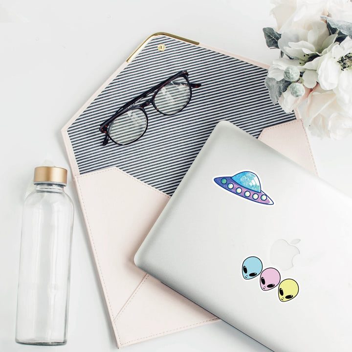 VibeCore Alien Stickers applied to a laptop, featuring quirky alien and UFO designs, adding a fun, futuristic touch to your tech accessories.