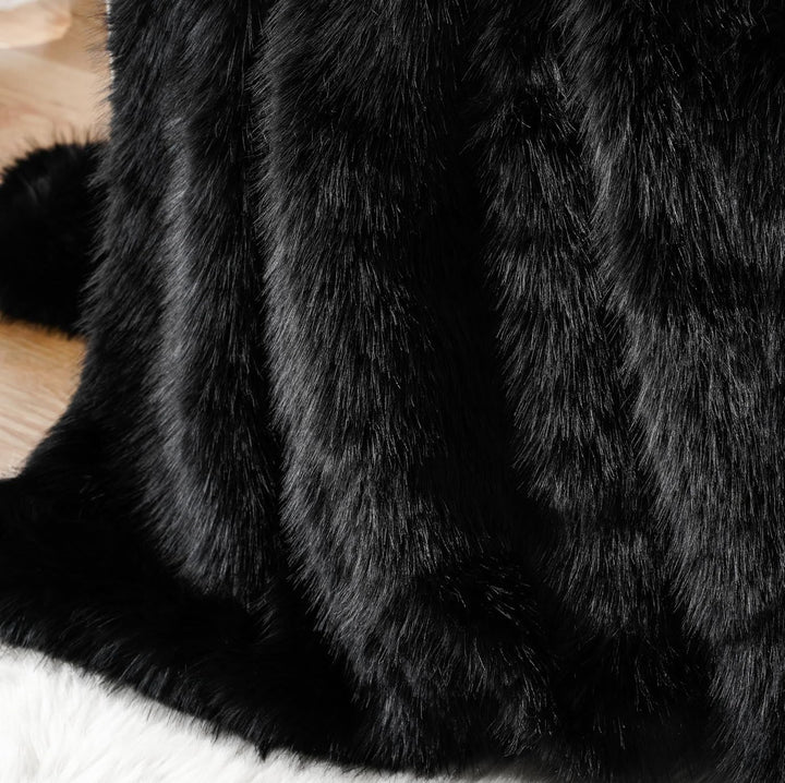 Close-up of a black Arctic Dream Faux Fur Throw Blanket, showcasing its soft, plush texture and luxurious European-inspired design. A cozy and elegant addition to any space.