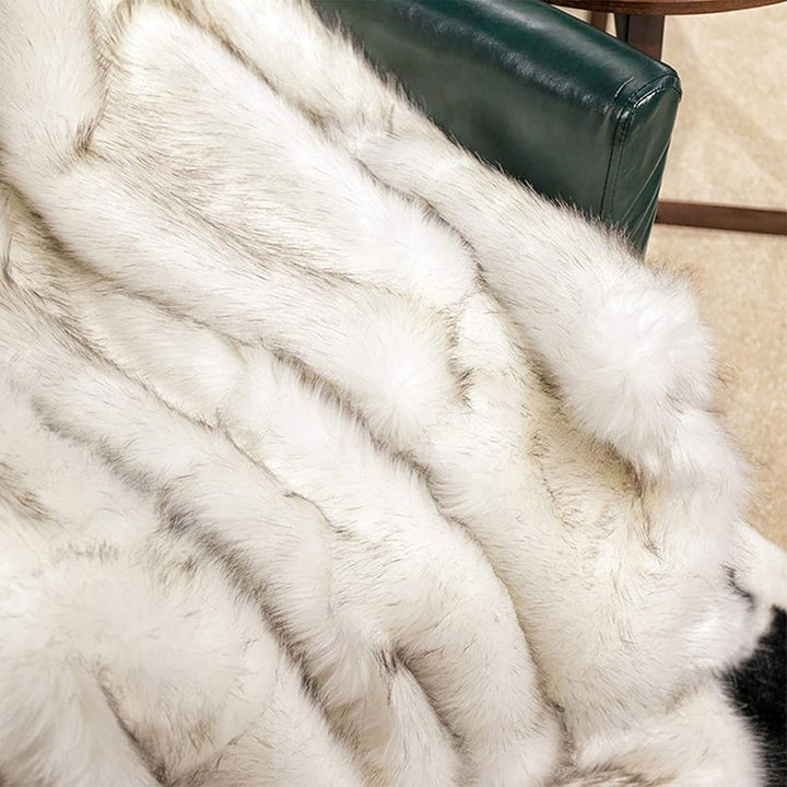 Close-up of a white Arctic Dream Faux Fur Throw Blanket, showcasing its soft, plush texture and luxurious, European-inspired design. A cozy and elegant addition to any space.
