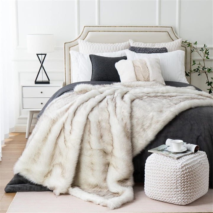 White Arctic Dream Faux Fur Throw Blanket draped over a bed, adding a touch of European elegance and luxurious comfort. Soft, plush, and perfect for enhancing your bedroom decor.
