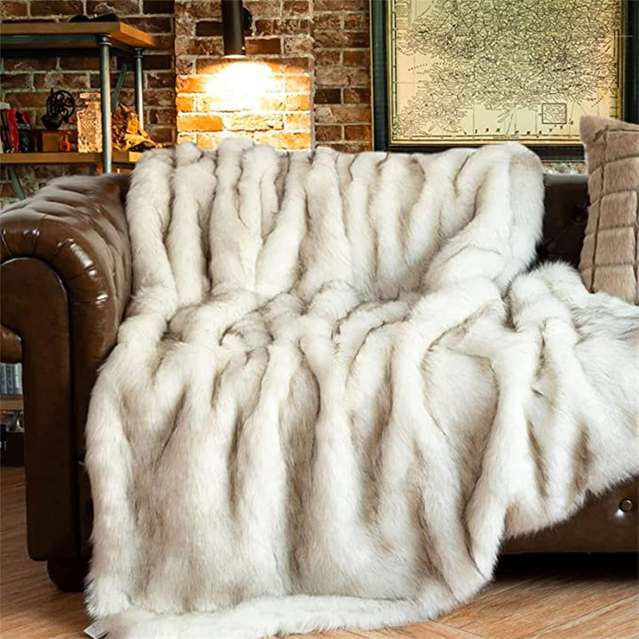 White Arctic Dream Faux Fur Throw Blanket draped over a sofa, offering a chic European-inspired design and luxurious comfort. Soft, plush, and perfect for adding elegance to any room.