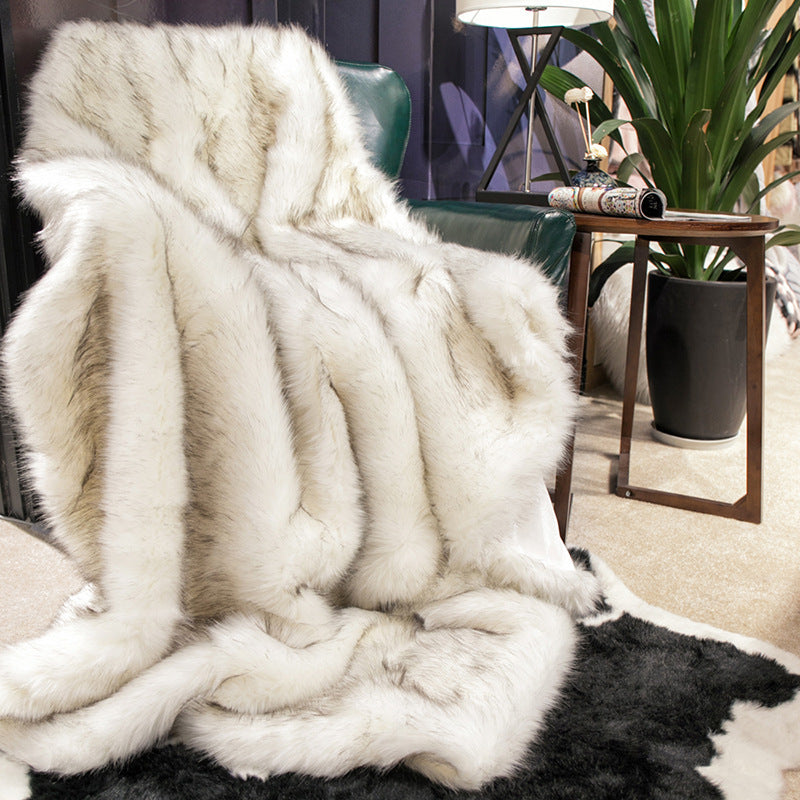 White Arctic Dream Faux Fur Throw Blanket draped over a sofa chair, adding European-inspired elegance and cozy comfort to your space. Soft, plush, and stylish, perfect for any room.