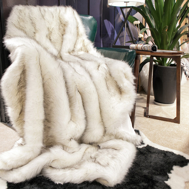 White Arctic Dream Faux Fur Throw Blanket draped over a sofa chair, adding European-inspired elegance and cozy comfort to your space. Soft, plush, and stylish, perfect for any room.