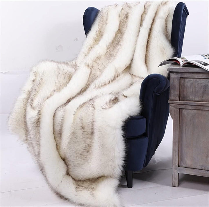 White Arctic Dream Faux Fur Throw Blanket draped over a chair, adding a luxurious, European-inspired touch. Soft, plush, and perfect for creating a cozy, elegant atmosphere in any room.