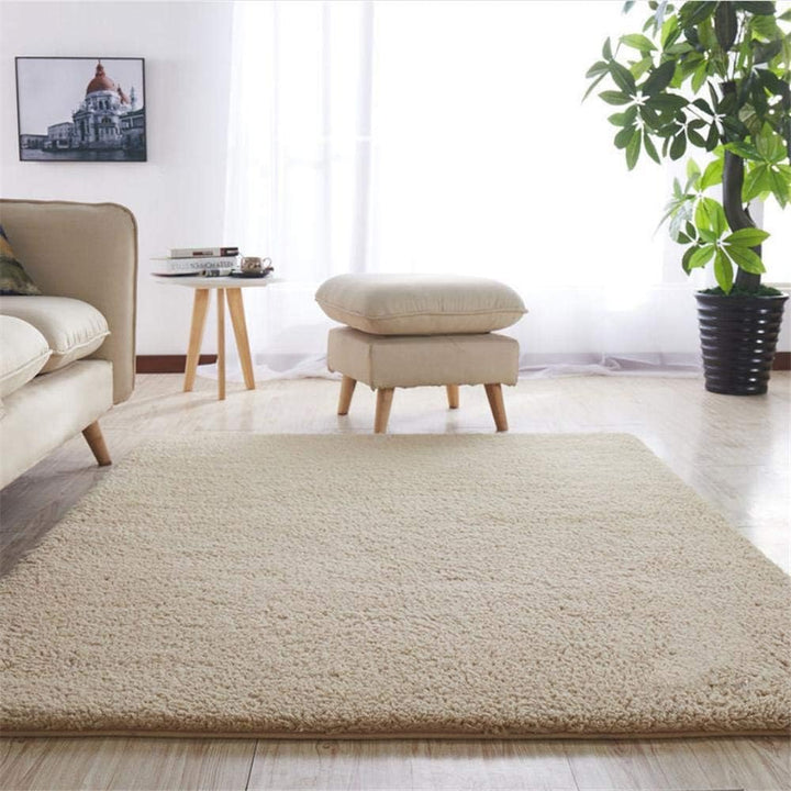 VibeCore Arctic Faux Cashmere Area Rug in beige placed in a living room, featuring a soft faux cashmere texture with non-slip backing. Adds warmth and luxury to any space, perfect for enhancing comfort and style. Easy to clean and available in 11 color options.