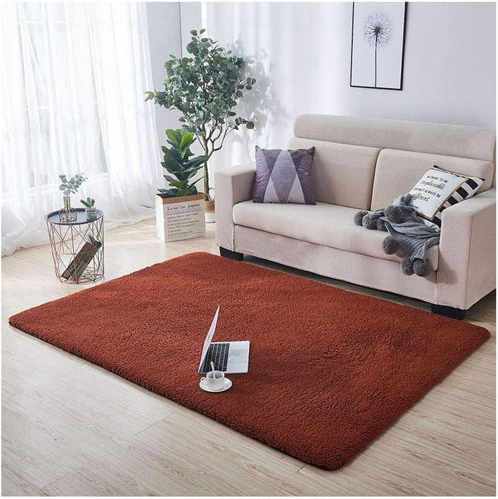 VibeCore Arctic Faux Cashmere Area Rug in coffee, aerial view in a living room, highlighting its soft faux cashmere texture and non-slip backing. Adds warmth and luxury to your space, perfect for creating a cozy atmosphere. Easy to clean and available in 11 color options.