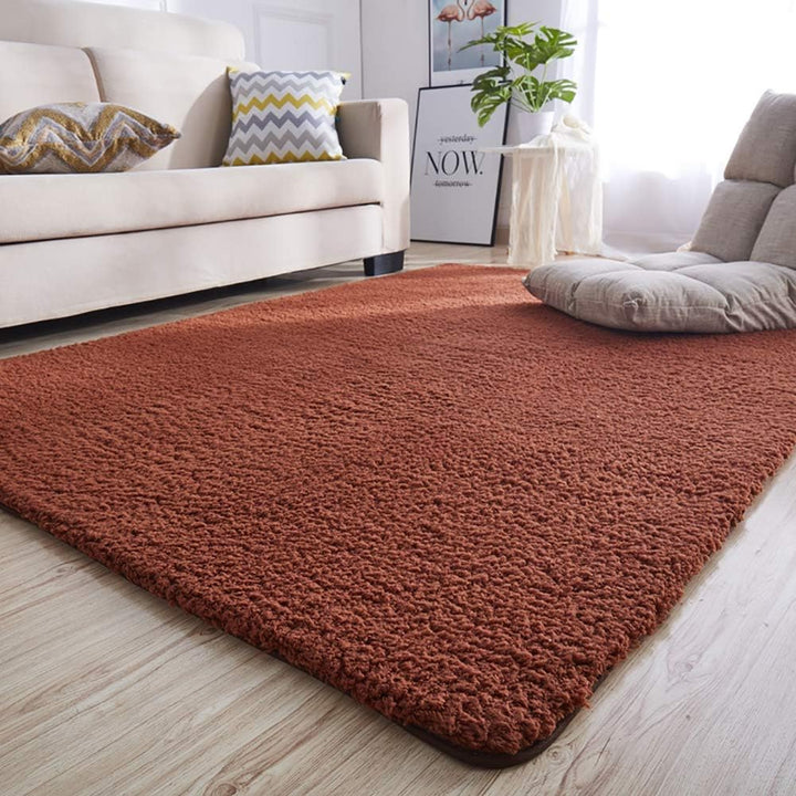 VibeCore Arctic Faux Cashmere Area Rug in coffee placed in a living room, featuring a soft faux cashmere texture with non-slip backing. Adds warmth and luxury to any space, perfect for enhancing comfort and style. Easy to clean and available in 11 color options.
