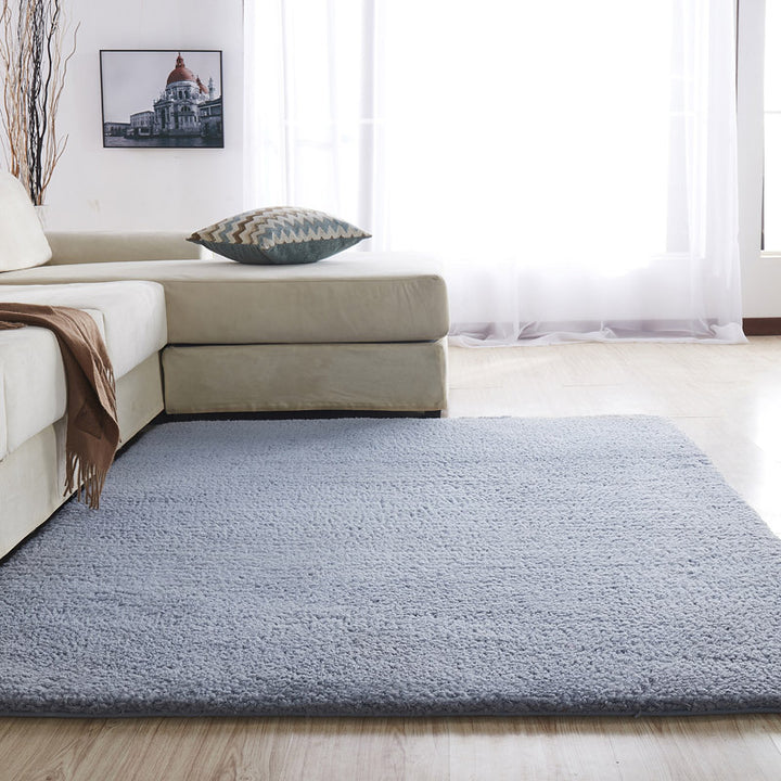 VibeCore Arctic Faux Cashmere Area Rug in gray, made from soft faux cashmere for a plush feel. Non-slip backing for safety, ideal for bedrooms, living rooms, or dorms. Durable, easy to clean, and available in 11 color options.