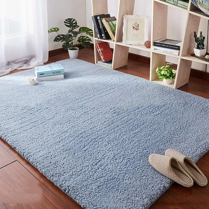 VibeCore Arctic Faux Cashmere Area Rug in gray on the floor, showcasing its soft faux cashmere texture and non-slip backing. Adds a cozy, luxurious touch to any room. Durable, easy to clean, and available in 11 color options.