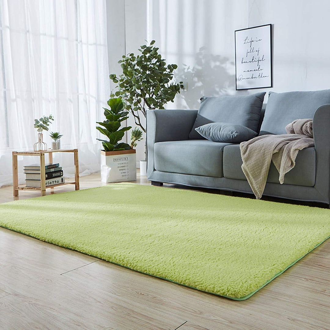 VibeCore Arctic Faux Cashmere Area Rug in matcha green placed in a living room, featuring a soft faux cashmere texture with non-slip backing. Adds warmth and luxury to any space, perfect for enhancing comfort and style. Easy to clean and available in 11 color options.