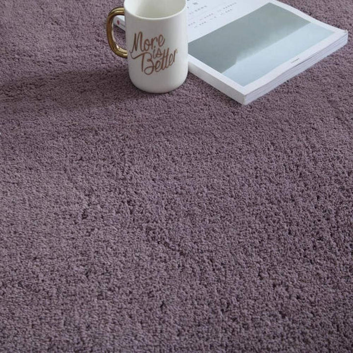 VibeCore Arctic Faux Cashmere Area Rug in purple gray, close-up view showcasing its soft faux cashmere texture. Non-slip backing for safety, perfect for adding luxury and comfort to any room. Easy to clean and available in 11 color options.