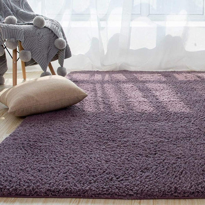 VibeCore Arctic Faux Cashmere Area Rug in purple gray on the floor, showcasing its soft faux cashmere texture and non-slip backing. Adds a cozy, luxurious touch to any room. Durable, easy to clean, and available in 11 color options.