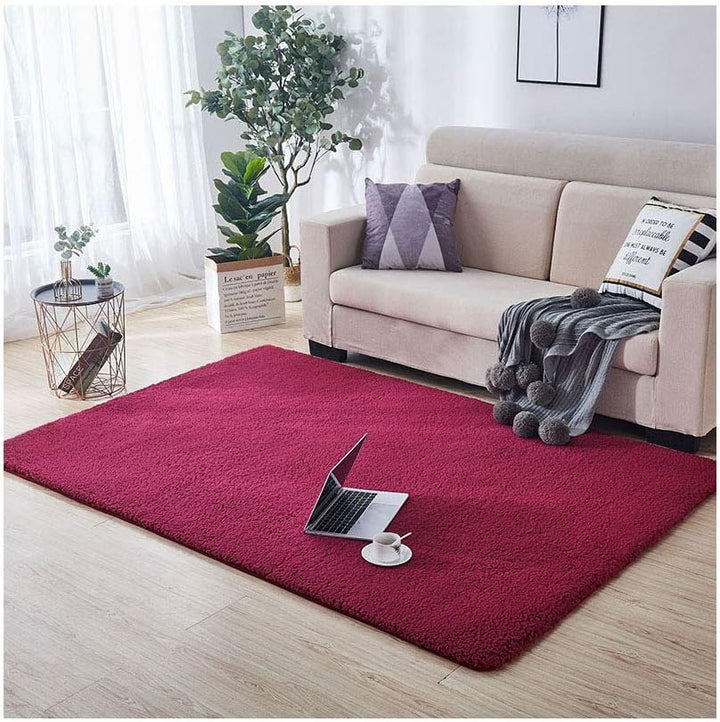 VibeCore Arctic Faux Cashmere Area Rug in red wine placed in a living room, featuring a soft faux cashmere texture with non-slip backing. Adds warmth and luxury to any space, perfect for enhancing comfort and style. Easy to clean and available in 11 color options.