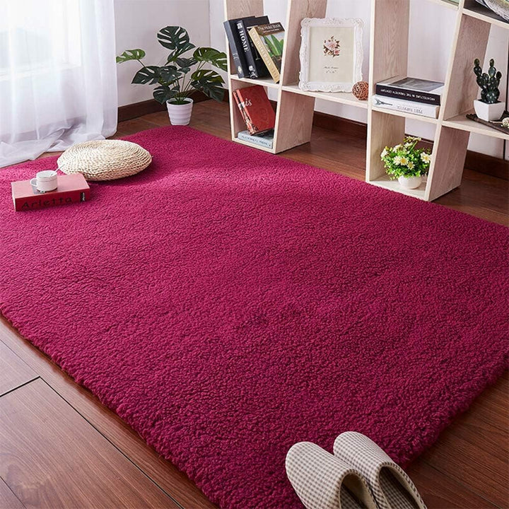 VibeCore Arctic Faux Cashmere Area Rug in red wine on the floor, showcasing its soft faux cashmere texture and non-slip backing. Adds a cozy, luxurious touch to any room. Durable, easy to clean, and available in 11 color options.