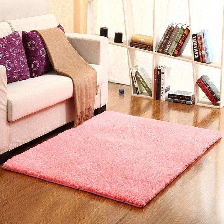 VibeCore Arctic Faux Cashmere Area Rug in watermelon pink placed in a living room, featuring a soft faux cashmere texture with non-slip backing. Adds warmth and luxury to any space, perfect for enhancing comfort and style. Easy to clean and available in 11 color options.