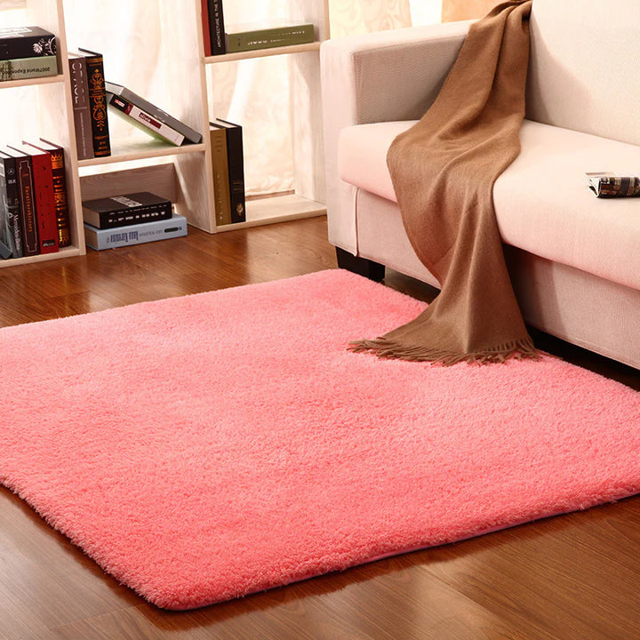 VibeCore Arctic Faux Cashmere Area Rug in watermelon pink on the floor, showcasing its soft faux cashmere texture and non-slip backing. Adds a cozy, luxurious touch to any room. Durable, easy to clean, and available in 11 color options.