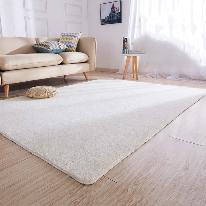 VibeCore Arctic Faux Cashmere Area Rug in white close-up view in a living room, highlighting its soft faux cashmere texture and non-slip backing. Adds warmth and luxury to your space, perfect for enhancing comfort and style. Easy to clean and available in 11 color options.