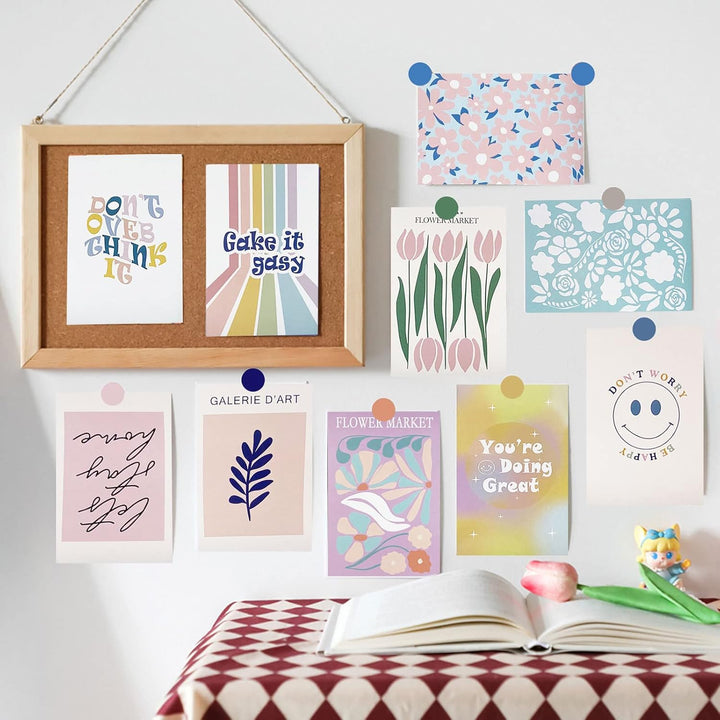 VibeCore Artsy Good Vibes Wall Collage Kit on wall with tacks, showcasing 70 uplifting pastel prints and vibrant Danish-inspired designs. This setup adds feel-good vibes, artsy decor, and cheerful pastel accents to your space, making it easy to create a dynamic, personalized wall art display.