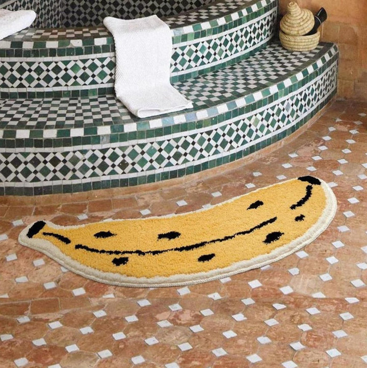 VibeCore Banana Accent Rug placed in a bathroom, showcasing a playful banana design with soft, fluffy texture and non-slip backing, enhancing the space with a fun, vibrant touch.