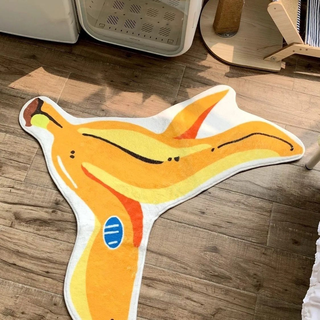 Close-up of the VibeCore Banana Peel Accent Rug on a bedroom floor, showcasing its playful yellow hue, quirky banana peel design, soft plush texture, and non-slip backing. A fun, cute rug that adds personality and comfort to modern bedroom or dorm decor.