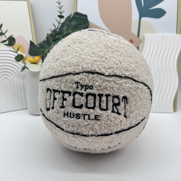 VibeCore Basketball Decorative Pillow - White on table front view, featuring a bold basketball design, ideal for adding a sporty and stylish accent to your home or dorm decor.