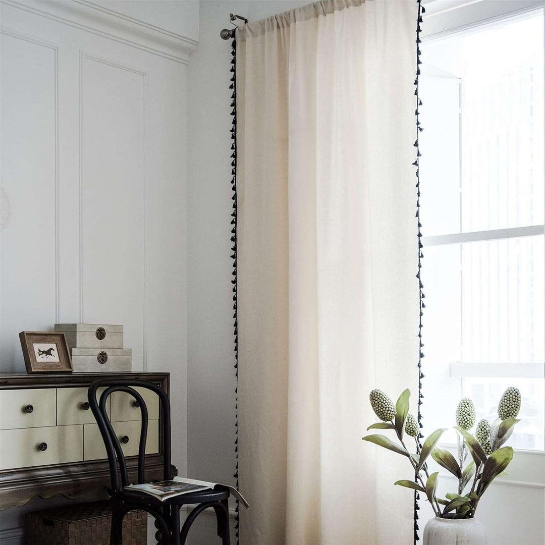 Elevate your space with a touch of boho chic using this soft, high-quality linen curtain with tassel accents. Its neutral beige hue enhances natural light while maintaining privacy. Perfect for any cozy corner or room in your home.