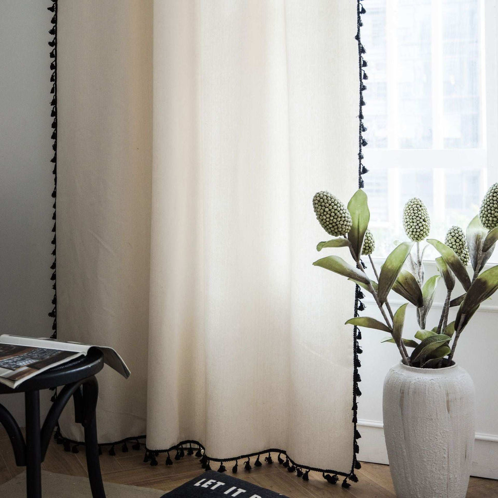 Beige tassel linen curtain bottom close-up showing delicate tassel details and soft fabric texture.