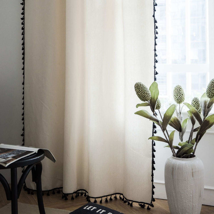 Beige tassel linen curtain bottom close-up showing delicate tassel details and soft fabric texture.