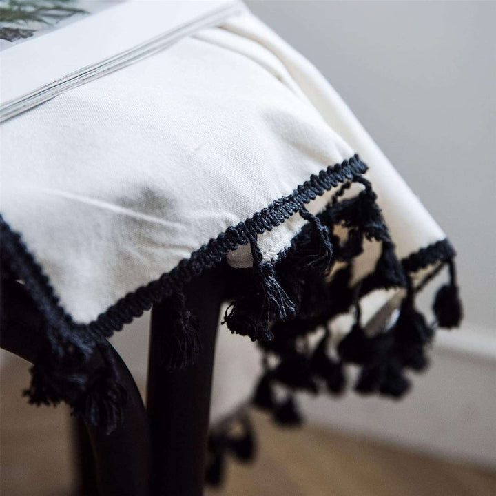 Close-up of beige tassel linen curtain, showcasing the soft fabric and intricate tassel details.