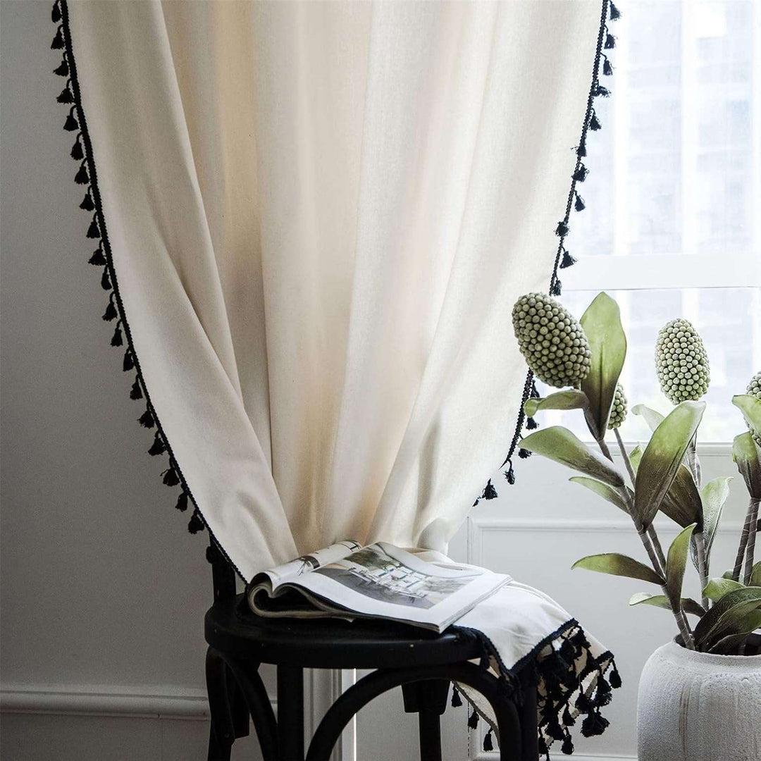 Beige tassel linen curtain draped on a window, creating a soft, light-filtered ambiance with tassel accents.