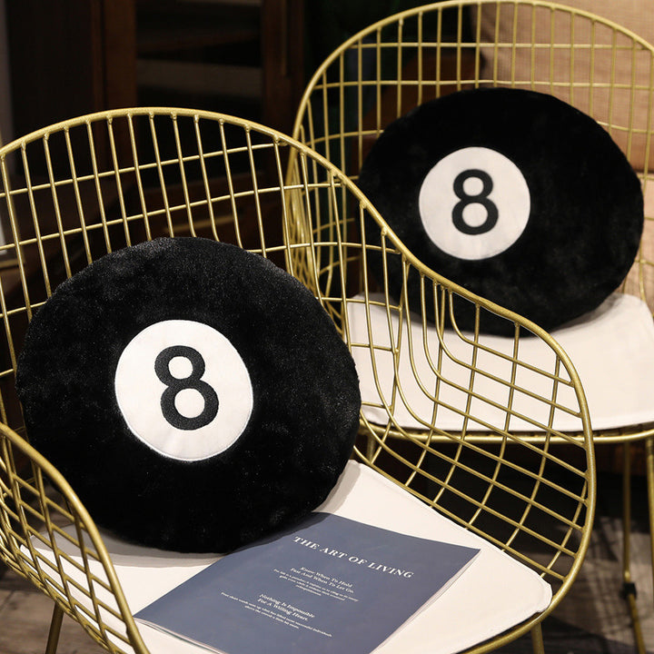VibeCore Billiard Ball Throw Pillow featuring bold magic 8 ball design, placed on two chairs. Soft, ultra-comfy fabric pillow perfect for adding a playful, trendy vibe to game rooms, bedrooms, or dorms. Available in two sizes, combining comfort with style.
