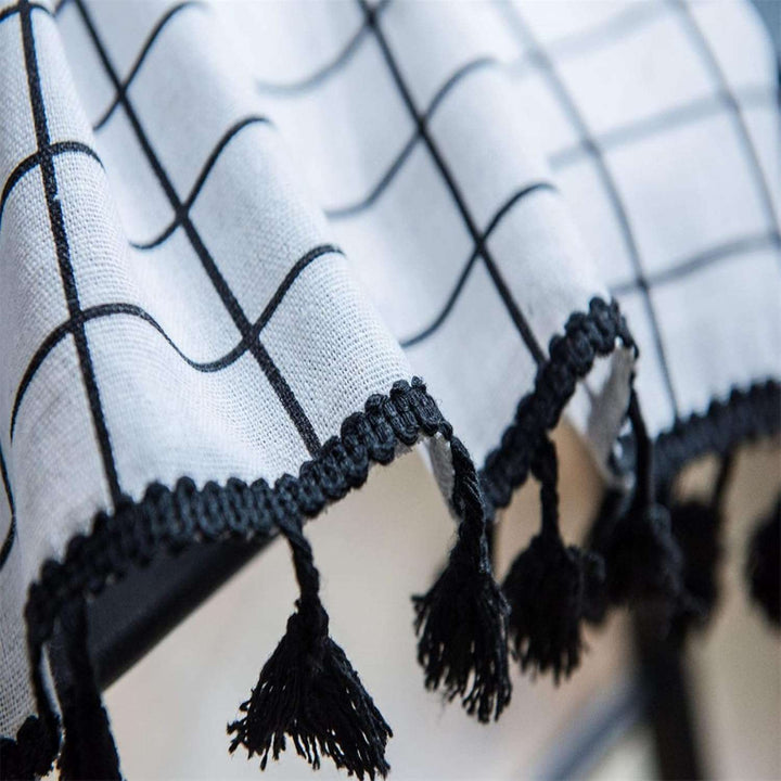 VibeCore Black & White Grid Tassel Linen Curtain tassel close-up, highlighting playful tassels paired with a bold grid pattern, crafted from a soft cotton-linen blend for a chic, bohemian touch.