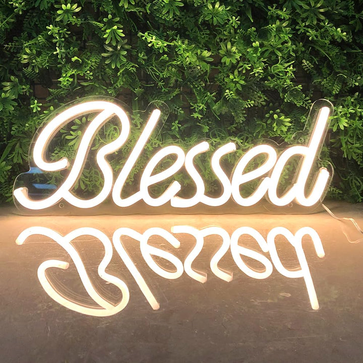 VibeCore Blessed Neon Light With Boxwood Behind With Light Reflecting On Surface