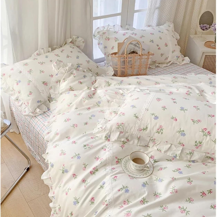 VibeCore Blossom French Ruffles Duvet Cover Set by window, angled close-up, highlighting soft cotton fabric, intricate ruffles, and delicate floral details for a charming, elegant touch.