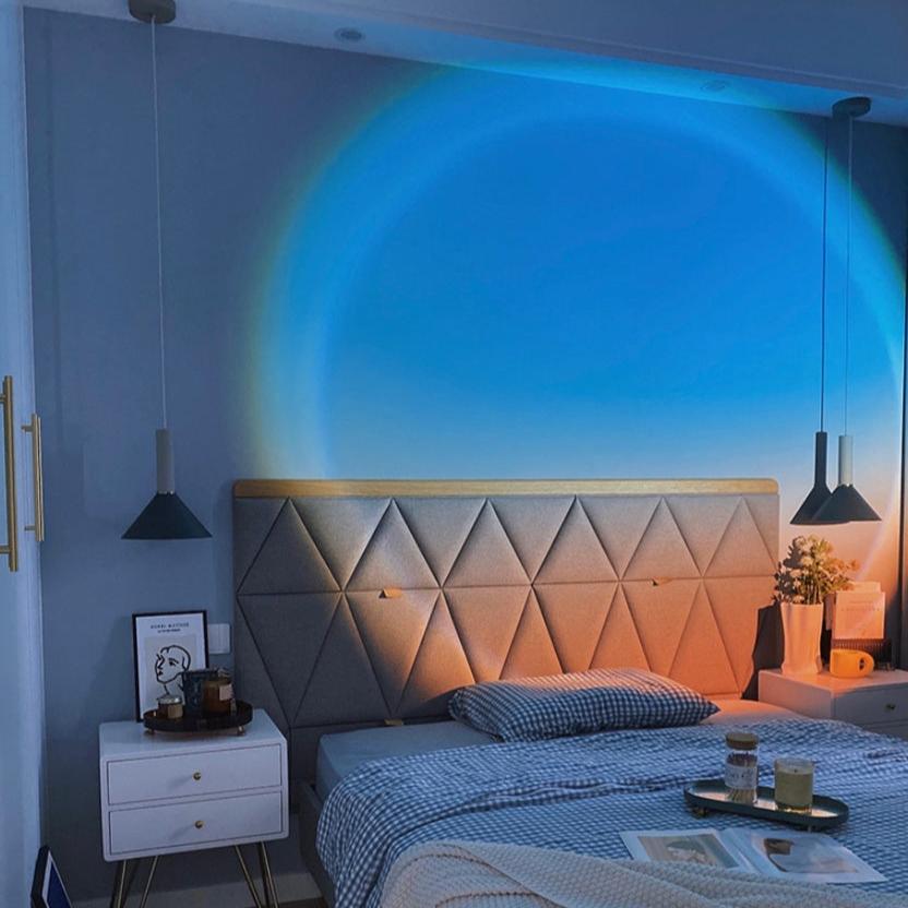 VibeCore Blue Sunset Lamp projecting blue and orange hues on a wall, creating a calming, ambient atmosphere. USB-powered with a long cord, adjustable height, and energy-efficient low voltage, this lamp adds mood lighting and a stylish touch to any space. Perfect for enhancing room decor and setting the vibe.