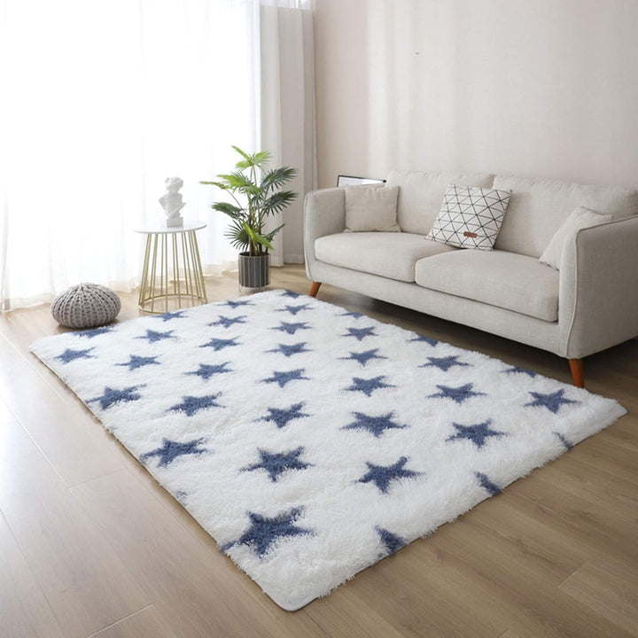 VibeCore Blue & White Stars Area Rug on living room floor, featuring a dreamy starry design and soft, plush texture. The non-slip backing keeps it securely in place while adding a celestial vibe to your space.