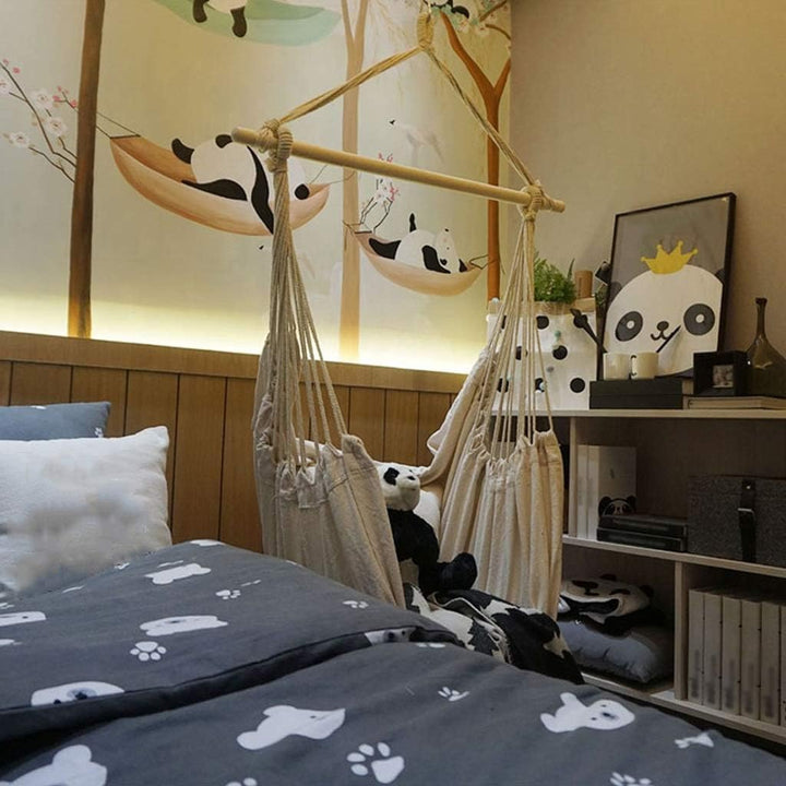 Aesthetic Bohemia style hanging hammock chair hanging in a bedroom made of high-quality cotton thread perfect for adding a cozy, bohemian touch to your indoor space while providing durable comfort for lounging or reading.