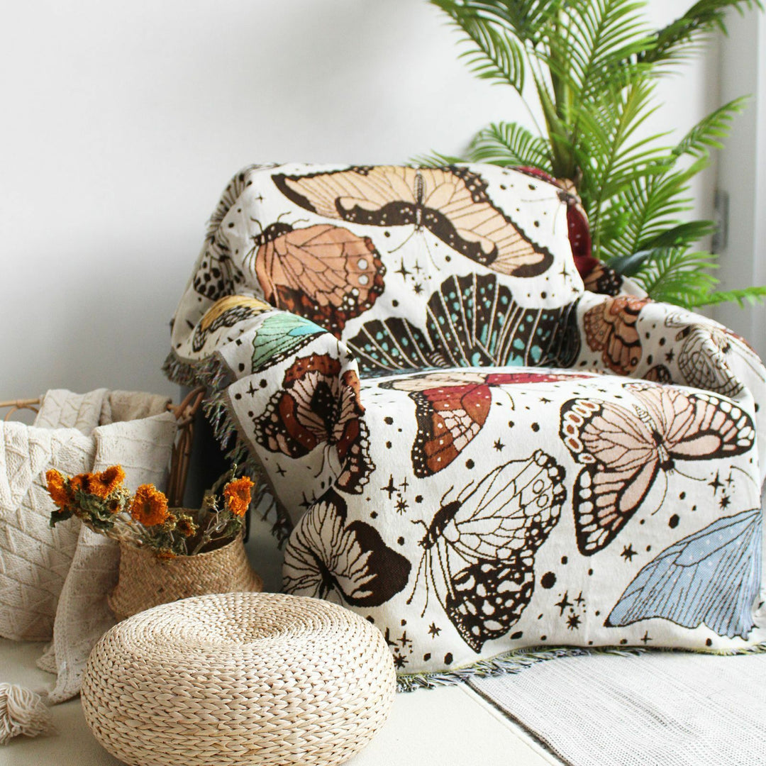 VibeCore Butterflies Woven Blanket as a chair cover, showcasing a vibrant butterfly pattern design and soft 100% combed cotton texture.