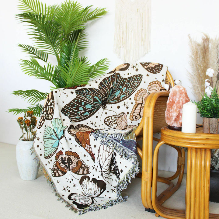 VibeCore Butterflies Woven Blanket on chair, featuring a vibrant butterfly pattern design and soft 100% combed cotton fabric.