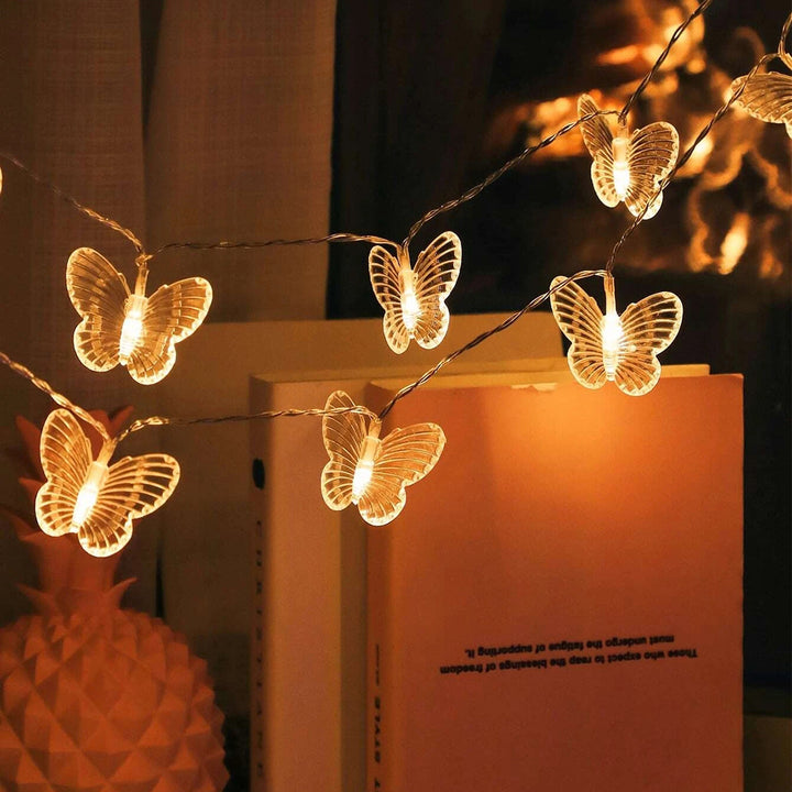 Close-up of VibeCore Butterfly String Lights hanging, showcasing delicate butterfly designs and warm white glow.