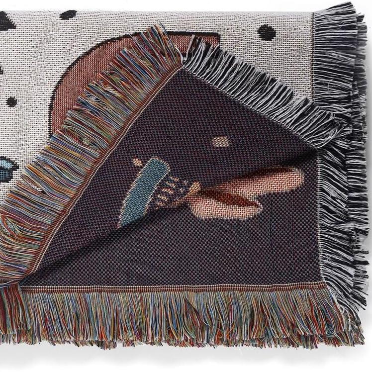 VibeCore Cactus & Crystals Woven Blanket neatly folded, displaying its earthy cactus and crystal design with soft, reversible cotton texture.