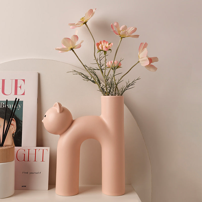VibeCore Cat Ceramic Vase in light pink with flowers inside, showcasing its adorable cat-shaped design and glossy glazed finish for a charming display.