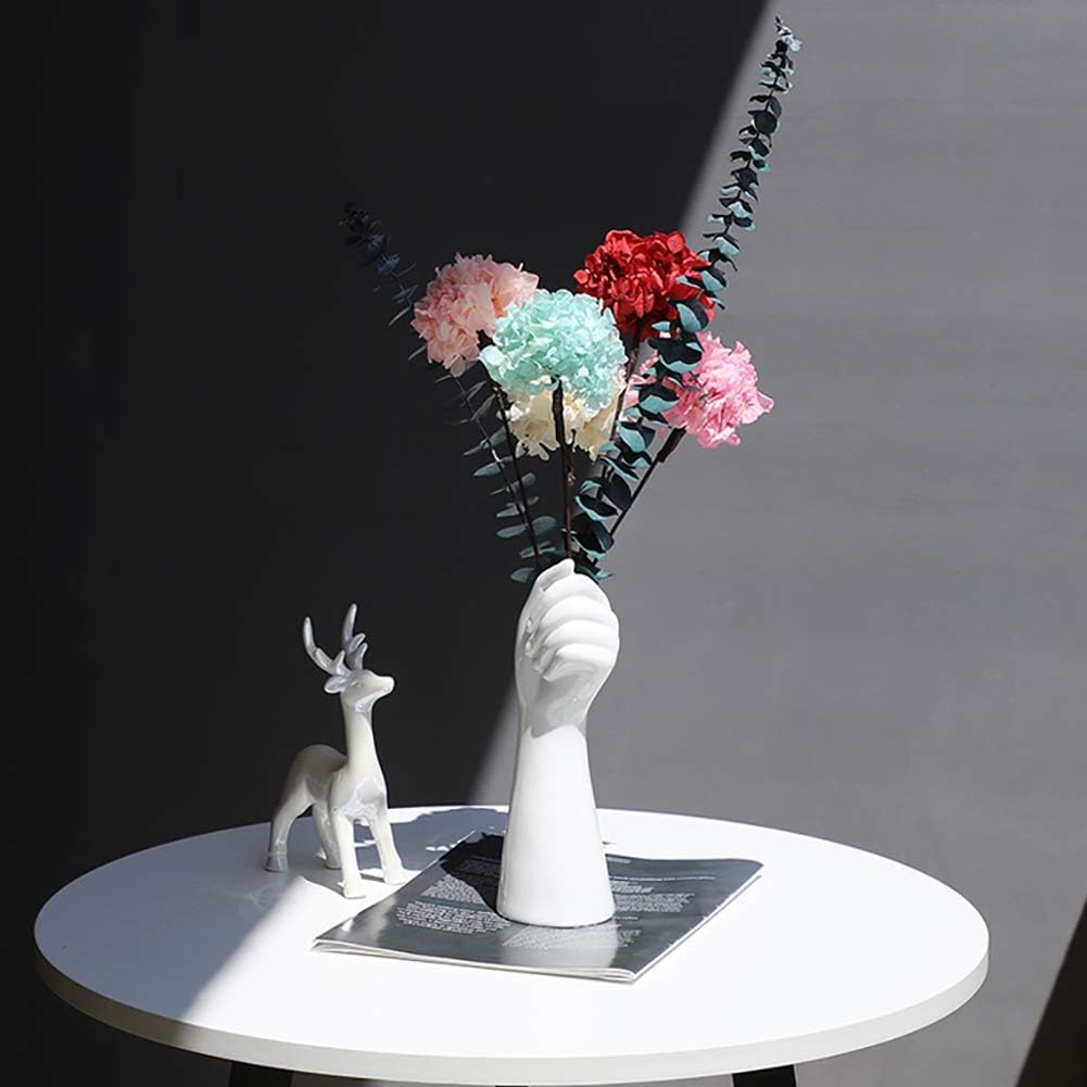 VibeCore Ceramic Hand Vase holding flowers, elegant hand-shaped design in porcelain, showcasing artificial flowers for a timeless and minimalist decor.