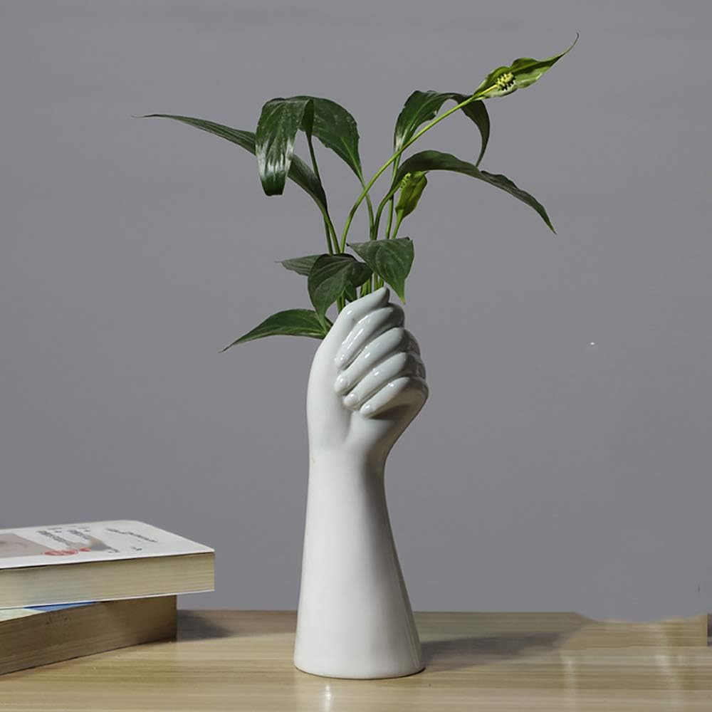 VibeCore Ceramic Hand Vase holding greenery, sculptural design inspired by Greek and Roman art, minimalistic hand-shaped vase displaying artificial flowers or decorative fillers.