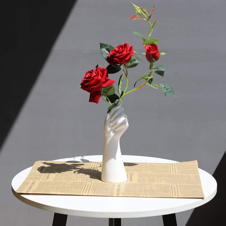 VibeCore Ceramic Hand Vase holding roses, sculptural hand-shaped design inspired by Greek and Roman art, minimalist vase displaying artificial roses for elegant decor.
